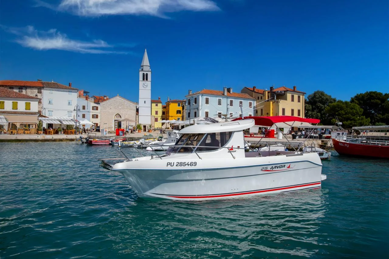Fažana harbor at golden hour with boats